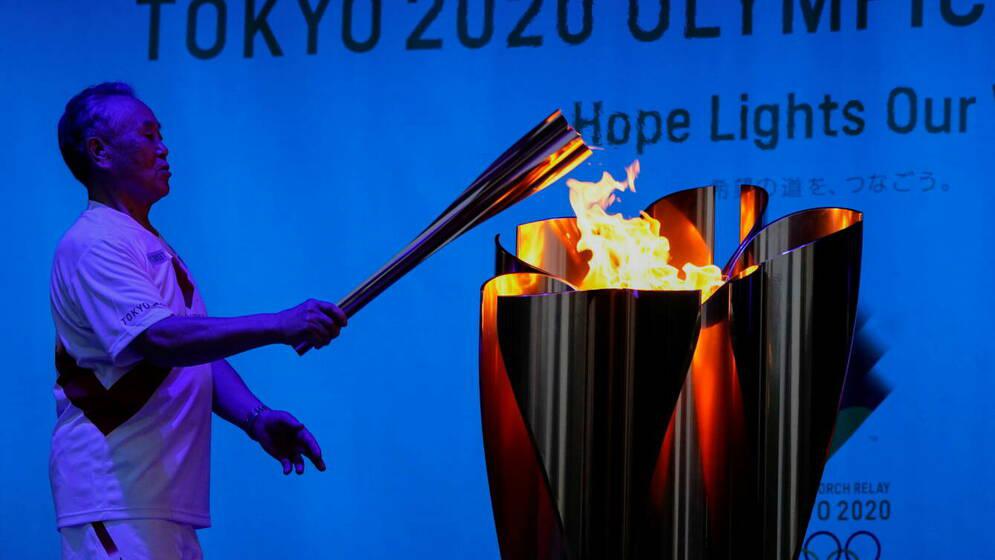 the-celebration-cauldron-is-lit-during-a-torch-kiss-event-at-tokyo-2020-olympic-torch-relay-celebration-at-shiba-park-in-tokyo-japan-july-22-2021-reuters-naoki-ogura