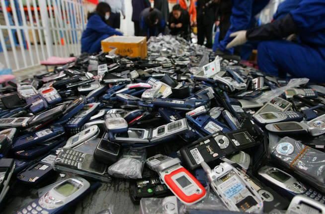 fuz02-pekin-china-2-12-2009-trabajadores-desmantelan-falsos-telefonos-moviles-reproductores-de-musica-y-relojes-para-reciclaje-hoy-jueves-3-de-diciembre-de-2009-en-pekin-china-cerca-de-20-000-de-estos-productos-con